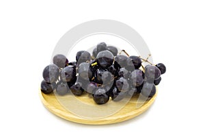 Fresh grapes on wooden plate isolated