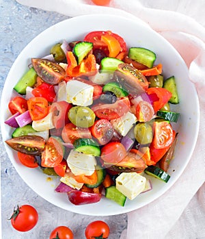 Fresh Greek salad with cheese in a white bowl