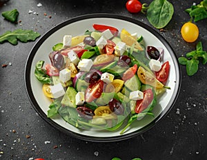 Fresh Greek salad with cucumber, cherry tomato, lettuce, red onion, feta cheese and black olives. Healthy food