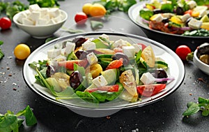 Fresh Greek salad with cucumber, cherry tomato, lettuce, red onion, feta cheese and black olives. Healthy food