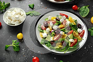 Fresh Greek salad with cucumber, cherry tomato, lettuce, red onion, feta cheese and black olives. Healthy food