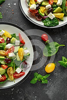 Fresh Greek salad with cucumber, cherry tomato, lettuce, red onion, feta cheese and black olives. Healthy food