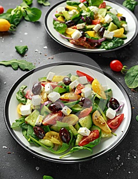 Fresh Greek salad with cucumber, cherry tomato, lettuce, red onion, feta cheese and black olives. Healthy food