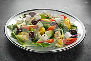 Fresh Greek salad with cucumber, cherry tomato, lettuce, red onion, feta cheese and black olives. Healthy food