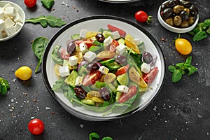 Fresh Greek salad with cucumber, cherry tomato, lettuce, red onion, feta cheese and black olives. Healthy food