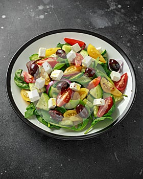 Fresh Greek salad with cucumber, cherry tomato, lettuce, red onion, feta cheese and black olives. Healthy food