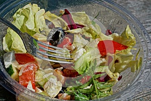 Fresh greek salad food in a plastic transparent box