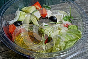 Fresh greek salad food in a plastic transparent box