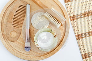 Fresh greek yogurt, make-up brush, loofah sponge, wooden hair comb and body brush. Ingredients for preparing homemade mask.