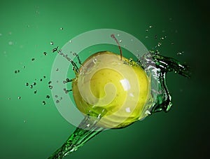 Fresh green apple in Water splashing stream on on Green background