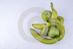 Fresh green apples, pears, bananas on a white wooden background. Concept healthy food photo