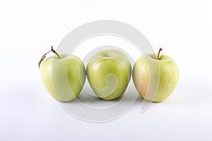 Fresh green apples on a white background. Three green apples on a white background.