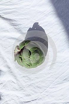 Fresh green artichoke on white background. Whole artichoke vertical mockup.