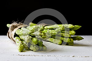 Fresh green asparagus on black background