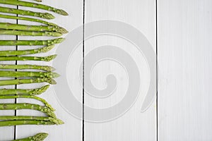 Fresh green asparagus buds on wooden table