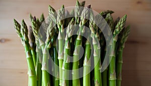 Fresh green asparagus bundle on wooden table