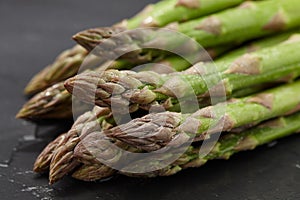 Fresh green asparagus close up on stone background