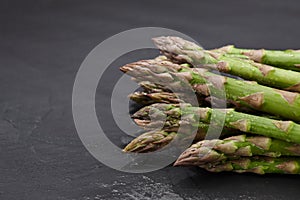 Fresh green asparagus close up on stone background