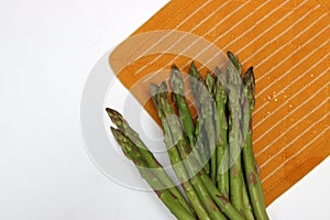 Fresh green asparagus in cotton mesh bag. Healthy living concept.