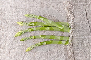 Fresh green asparagus on linen background copy space. Spring vegetables collection