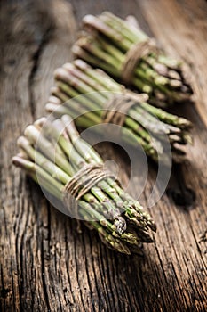 Fresh green asparagus on old oak table