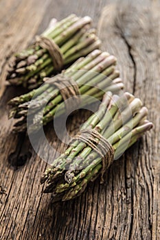 Fresh green asparagus on old oak table