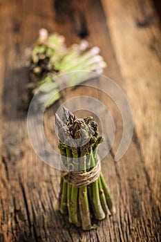 Fresh green asparagus on old oak table