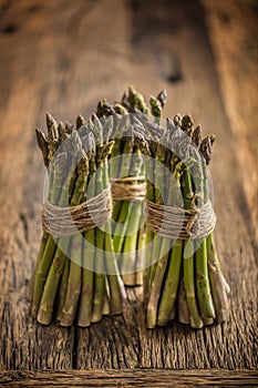 Fresh green asparagus on old oak table