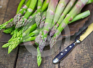 Fresh green asparagus on old wooden table