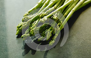 Fresh green asparagus raw food on black counter