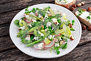 Fresh Green Asparagus salad witch Goat Cheese, peas, radishe, zucchini, lettuce and Hazelnuts.