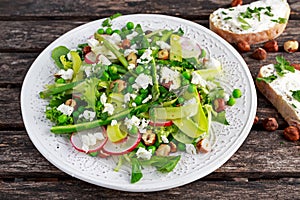 Fresh Green Asparagus salad witch Goat Cheese, peas, radishe, zucchini, lettuce and Hazelnuts.