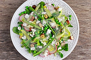 Fresh Green Asparagus salad witch Goat Cheese, peas, radishe, zucchini, lettuce and Hazelnuts.