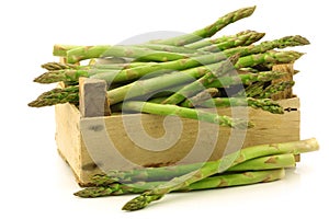 fresh green asparagus shoots in a wooden crate