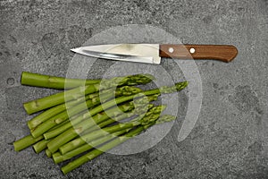 Fresh green asparagus on stone table surface