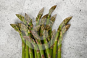 Fresh green asparagus on stone table surface