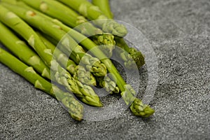Fresh green asparagus on stone table surface