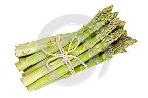 Fresh green asparagus tips in a row over white