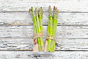 Fresh green asparagus on a white wooden background. Healthy food. Top view.