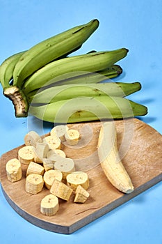 Fresh green banana on blue background, maqueno barraganete dominico