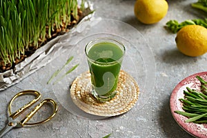 Fresh green barley grass juice in a glass cup