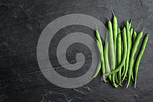 Fresh green beans on black table, flat lay. Space for text