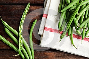 Fresh green beans on wooden table, flat lay