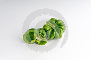 Fresh green bell peppers capsicum on a white background.