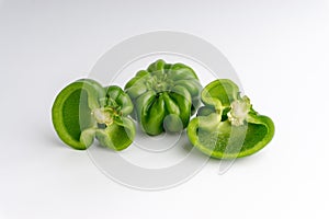 Fresh green bell peppers capsicum on a white background.