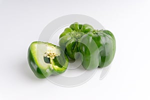 Fresh green bell peppers capsicum on a white background.