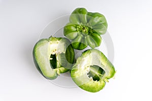 Fresh green bell peppers capsicum on a white background.