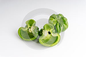 Fresh green bell peppers capsicum on a white background.