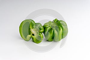 Fresh green bell peppers capsicum on a white background.