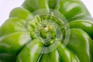 Fresh green bell peppers capsicum on a white background.